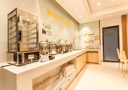 a kitchen with a counter with a coffee maker at City Comfort Inn Liuzhou The Mixc Xijiang Road in Liuzhou