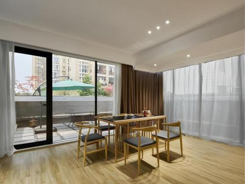 a dining room with a table and chairs and a large window at City Comfort Inn Liuzhou Wuling Liutai Road in Liuzhou