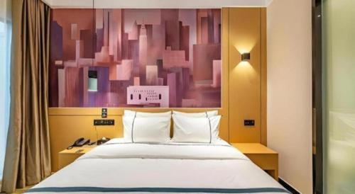 a bedroom with a bed and a painting on the wall at City Comfort Inn Chengdu Southwest University of Finance and Economics Wansheng Metro Station in Chengdu