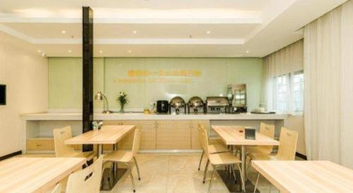 a restaurant with wooden tables and chairs and a counter at City Comfort Inn Changsha Window of the World Zhongmao City in Changsha