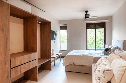 a bedroom with a bed and a large window at Family Apartment Steps from the Beach in Bucerías