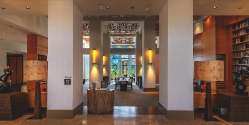 a lobby with columns and lamps and a library at Hyatt Regency Guam in Tumon