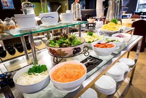 a buffet filled with bowls of food on a table at Hotel Sentral Johor Bahru @ Woodland Causeway in Johor Bahru