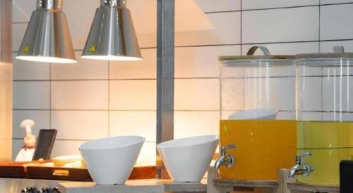 a kitchen with two white bowls on a counter at Borrman Hotel Yuxi Yuxing Road in Yuxi