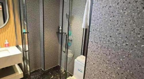 a bathroom with a shower and a toilet and a sink at City Comfort Inn Qingyuan Longtang Light Rail Changlong in Qingyuan