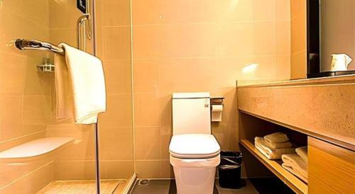 a bathroom with a toilet and a shower and a sink at City Comfort Inn Qingyuan Longtang Light Rail Changlong in Qingyuan