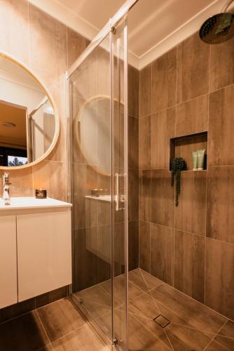 a bathroom with a shower and a sink at The Olive Leaf Retreat in Latrobe