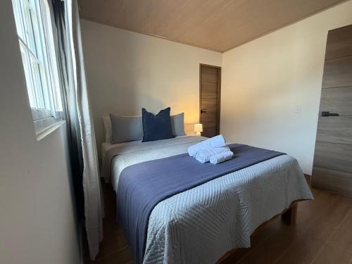 a bedroom with a bed with two towels on it at Casa Blu - Vacation home in Chitre in Chitré