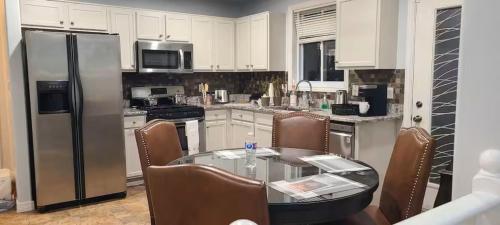 a kitchen with a glass table and stainless steel appliances at Full house, 3 BDR, 2WR, free Parking , extra beds in Windsor