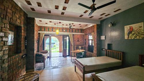 a living room with a table and a brick wall at Maison sangham in Varkala