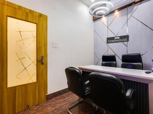 a waiting room with a table and chairs at Super Townhouse Royal Inn in Guwahati