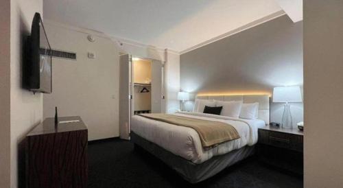 a hotel room with a large bed and a television at Ahern Hotel and Event Center in Las Vegas