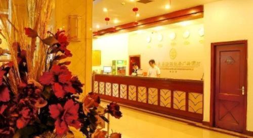 a man standing in a store with a counter at GreenTree Inn Luoyang Henan University of Science and Technology in Luoyang
