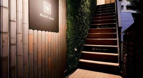 a set of stairs with a plant on the side of a building at HOSTEL LUND I -Oimachi- in Tokyo