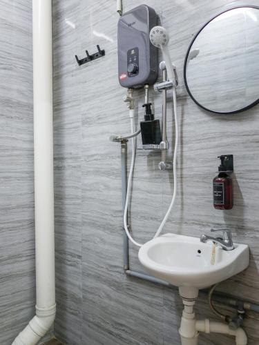 a bathroom with a sink and a mirror at Aayu Chulia - Chulia St, George Town in George Town