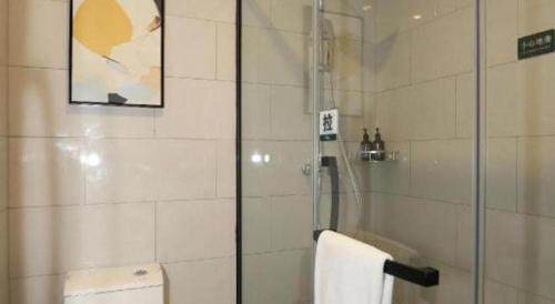a bathroom with a shower with a glass door at GreenTree Inn Express Fuyang University Town West High-Speed Railway Station in Fuyang