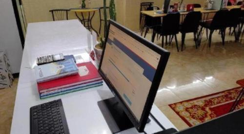 a laptop computer sitting on top of a table at Unique Hotel in Phnom Penh