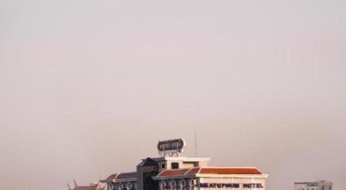 a building with a sign on top of it at Meatophum Samnang in Battambang