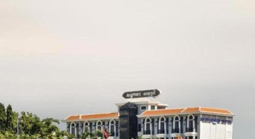 a large building with a sign on top of it at Meatophum Samnang in Battambang