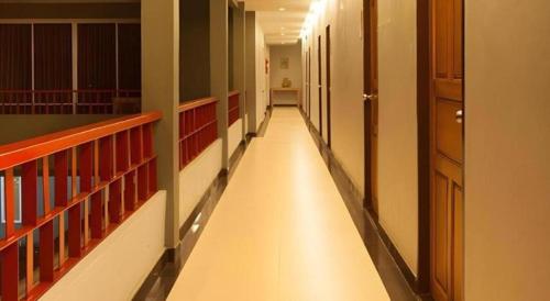 a hallway of a library with a long aisle at Soontree House Hotel in Udon Thani