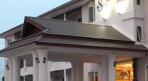 a large white building with columns and a roof at Siamtara Palace Hotel in Maha Sarakham