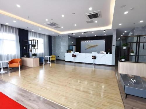 a large lobby with a large projection screen in a room at GreenTree Inn Express Jiangsu Taizhou North High-Speed Railway Station 