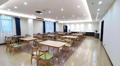 a dining room with tables and chairs in it at GreenTree Inn Express Jiangsu Taizhou North High-Speed Railway Station 