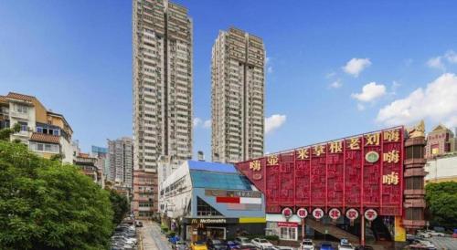 a city with tall buildings and a street with cars at ZMAX Hotels Shenzhen Lianhuacun Metro Station in Shenzhen