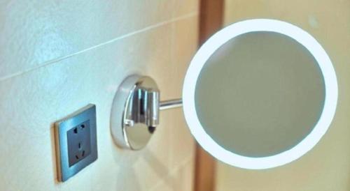 a bathroom with a mirror and a lightswitch at Lavande Hotel Changchun Gaoxin Jilin University in Changchun
