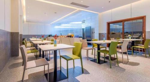 a restaurant with tables and chairs in a room at Borrman Hotel Chongqing Bishan Central Street in Chongqing