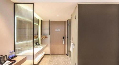 a bathroom with a shower and a sink at Borrman Hotel Chongqing Bishan Central Street in Chongqing