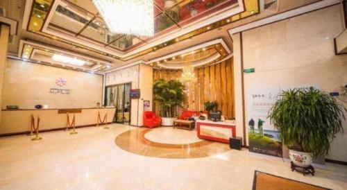 a large room with a lobby with potted plants at Milu Hotel in Guangzhou