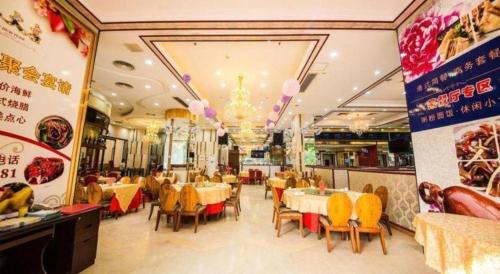 a dining room with tables and chairs in a restaurant at Milu Hotel in Guangzhou