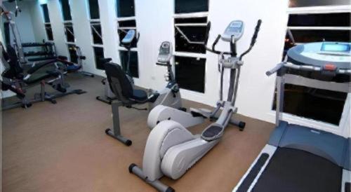 a gym with several exercise bikes in a room at V-One Hotel Korat in Nakhon Ratchasima