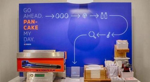 a blue wall with a drawing of a pain cave at Holiday Inn Express Wilkesboro By IHG in Wilkesboro