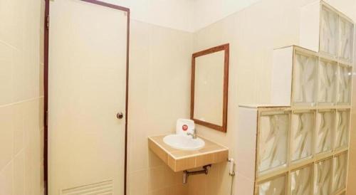 a bathroom with a sink and a mirror at Natee Place in Chiang Mai