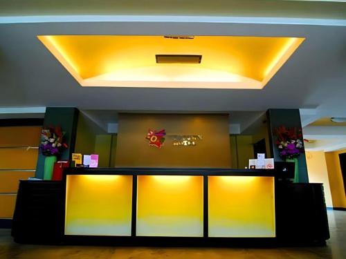 a lobby with yellow walls and a yellow ceiling at MO2 Westown Hotel San Juan in Bacolod