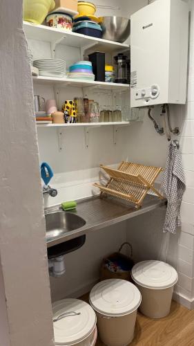 a kitchen with two toilets and a sink and cabinets at Lemon and avocado house in Portimão