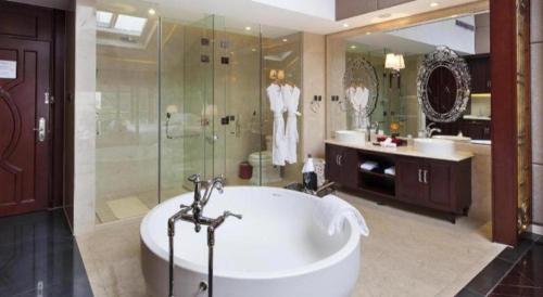 a large bathroom with a tub and a shower at Eden Club House in Tongxiang