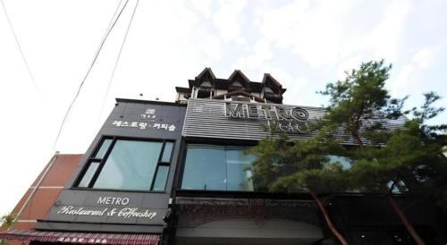a building with a sign on top of it at Metro Tourist Hotel Cheonan in Cheonan
