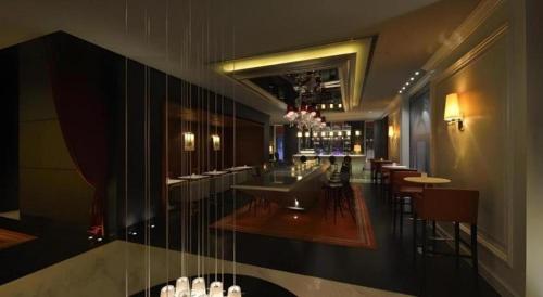 a restaurant with a bar with tables and chairs at Jinjiang Metropolo Hotel Classiq Shanghai Off Bund in Shanghai