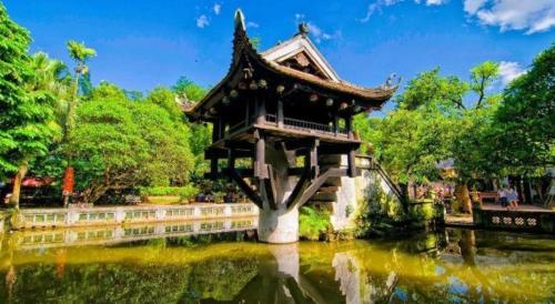 a building in the middle of a pond in a park at Ha Noi Vang Hotel Hoang Ngan in Hanoi