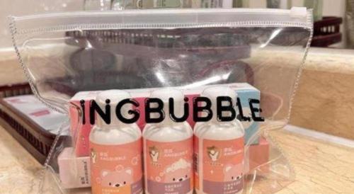 a plastic container with five bottles of milk in it at Kunming Jinjiang Hotel in Kunming