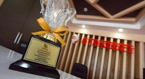 a trophy sitting on top of a table with a fence at GT Residence Hotel in Buriram