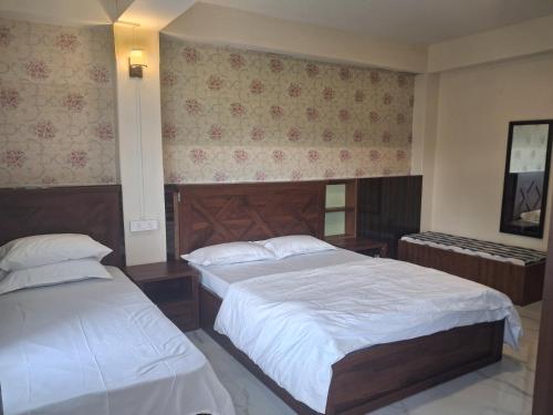 a hotel room with two beds at Nature Retreat in Gangtok