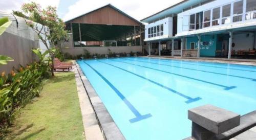a large swimming pool in a building at Umah Bali Suites in Denpasar