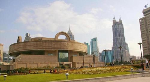 a building in the middle of a city with tall buildings at Shanghai Jinchen Hotel in Shanghai