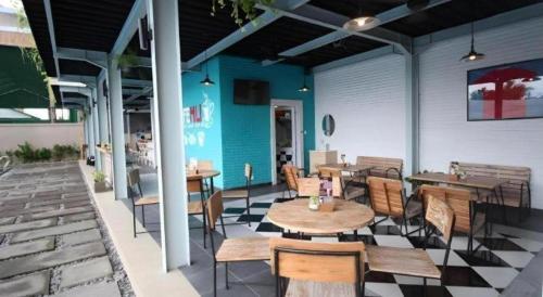 a restaurant with tables and chairs on a patio at Umah Bali Suites in Denpasar