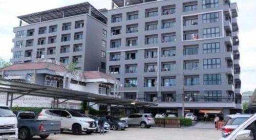 a large building with cars parked in front of it at Wsotel Hotel in Songkhla
