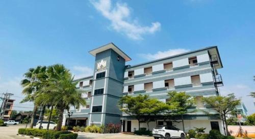 a building with a clock on the side of it at Thatphanom View Hotel Nakhon in Nakhon Phanom